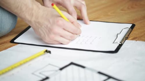 Close Up Of Male Hands Measuring Blueprint 8