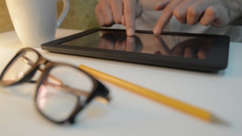 Drinking Coffee and Typing on Tablet