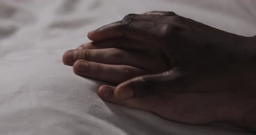 Multi-ethnic Couple in Love Lying in Bed Together
