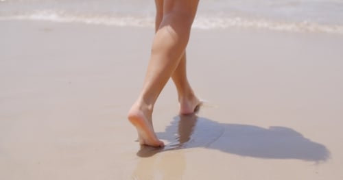 Close Up Woman Feet Walking At The Beach
