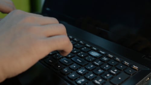 Hands Typing on Laptop Keyboard, Close Up