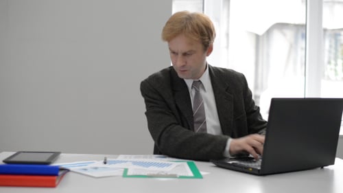 Businessman Working on Laptop in Office