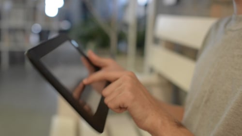 Close Up of Person Using Tablet