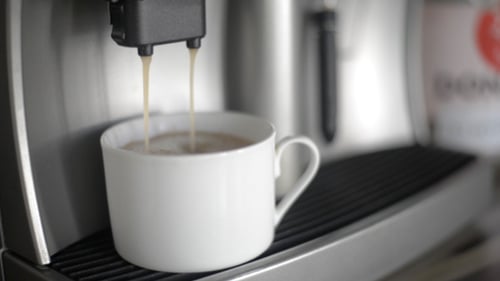 Espresso Machine Dispensing Coffee into White Mug