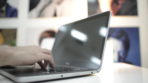 Hands Typing on Laptop