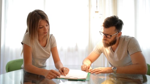 Couple Reading and Discussing documents