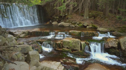 Picturesque Waterfall Flowing Through Forest Landscape
