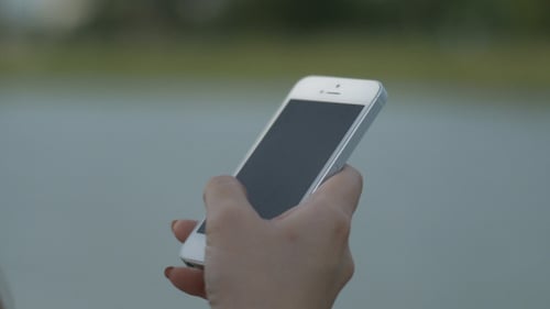 Woman Hand Swiping on Smartphone Screen