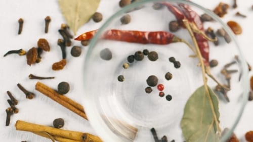 Peppercorns and Spices Filling Glass Bowl