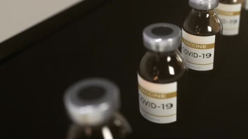 Vials of COVID-19 Vaccine on Dark Surface