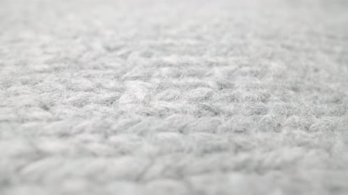 Extreme Detail View of Sheep Wool Cloth Texture Flowing in Macro Dolly Shot