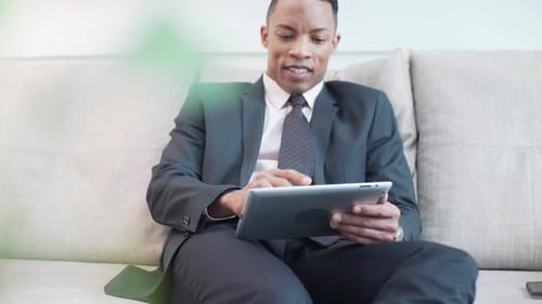 Mid adult man using digital tablet
