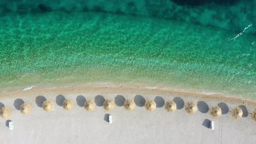 Aerial view on the seashore with umbrella. Vacation and adventure.