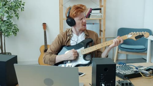 Redhead Man Plays Electric Guitar Enthusiastically