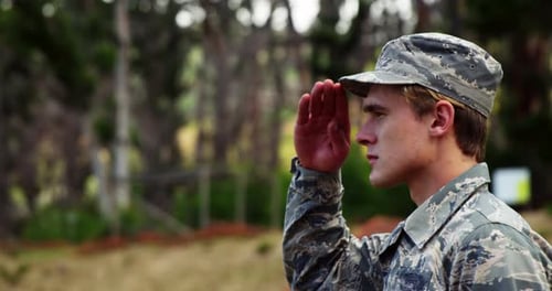 Person in Military Uniform Saluting Outdoors