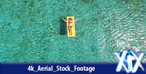 Woman Floating On Inflatable Raft Relaxing And Sun