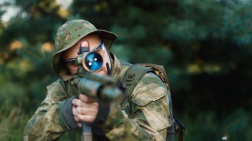 Man with Rifle in Camouflage Gear