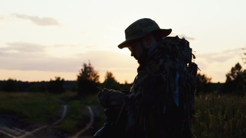 Man In Camouflage Speaking On The Radio