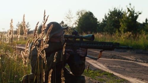 Man with Rifle in Rural Outdoor Setting