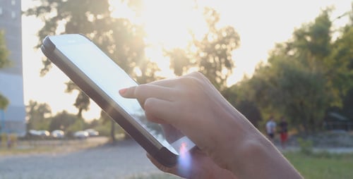 Mädchen bei Sonnenuntergang mit Touchpad