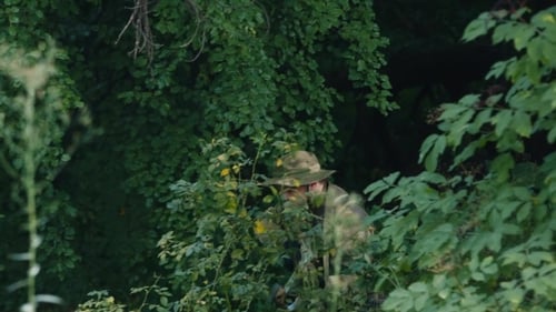 Armed Men Sneaking Through The Woods. Airsoft Game
