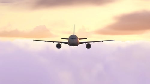 Airplane Flying Above Clouds Towards Beautiful Sunset