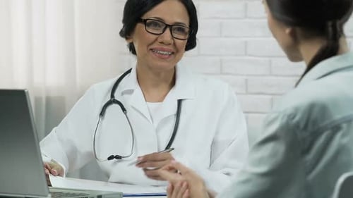 Doctor Consulting With Patient In Office