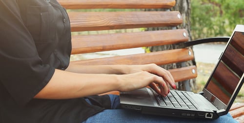 Girl Using a Laptop in the Park