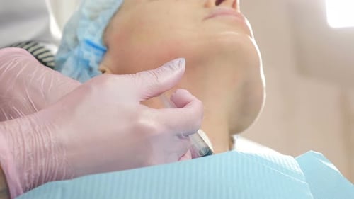 Female Patient Getting Botulinum Toxin Injections in Her Neck in Beauty Salon Beauty Clinic
