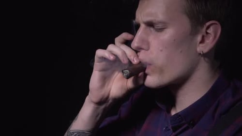 The Guy's Smoking a Cigar