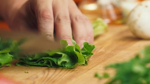 Lettuce Being Cut on a Cutting Board