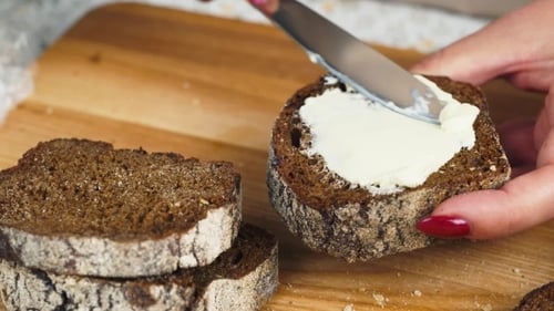 Spreading Cream Cheese on Rye Bread Slice