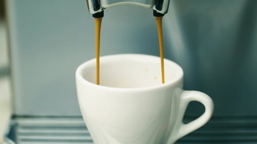 Coffee Machine Dispensing Espresso Into White Cup