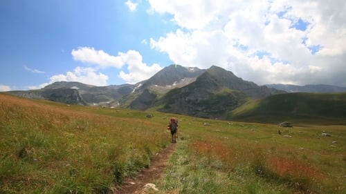Tourist Man In Mountain With Backpack