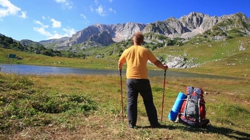 Tourist Man In Mountain With Backpack