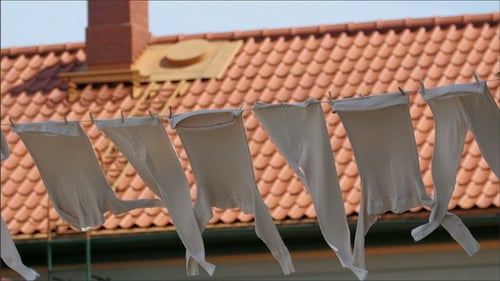 White Laundry Drying on Clothesline in Sunlight