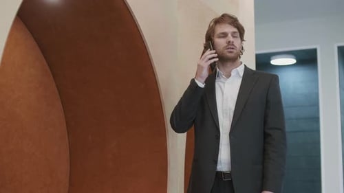 Handsome Man Talking on Cell Phone in Office