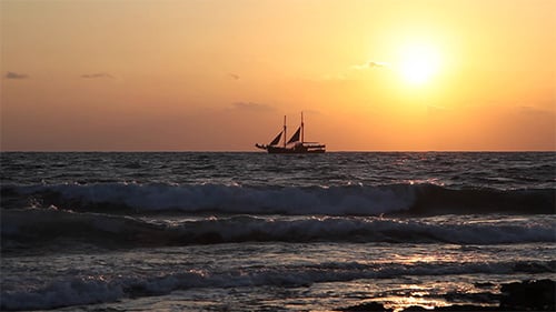 Picturesque Sailboat Sailing on Ocean at Golden Sunset