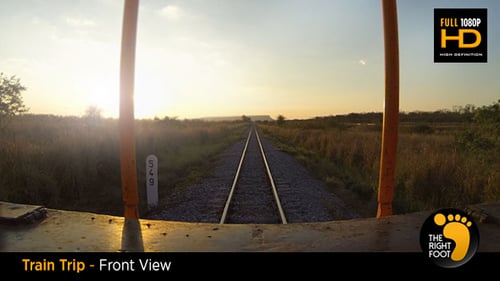 Train Tracks Through Golden Countryside at Sunset