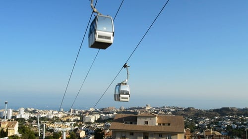 Cable Car Running in Coastal City at Sunset
