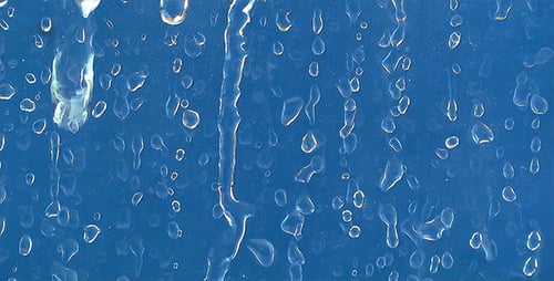 Water Droplets Flowing on Blue Surface