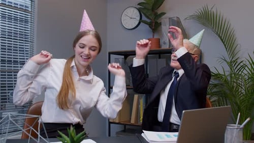 Smiling Secretary with Handsome Senior Businessman Company Director Dancing Victory Dance in Office