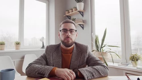 Professional Man Talking at Desk in Office