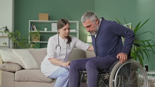 Woman Assisting Man in Wheelchair at Home