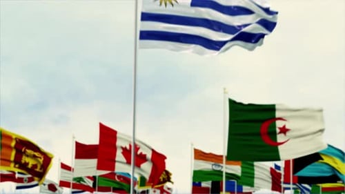 Uruguay Flag Waving Amidst Blurred International Flags