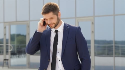 Young Adult Man Talking on Cellphone Outdoors
