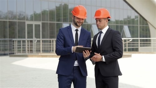 Two Architect Using a Tablet Outdoors