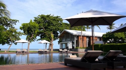 Resort Swimming Pool With Sun Lounger By The Sea