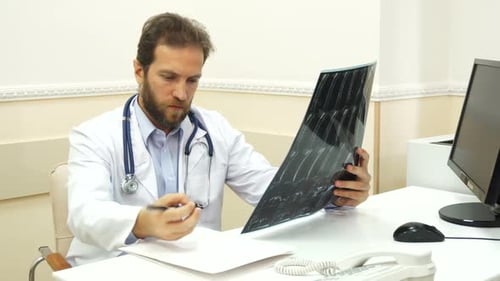 The Doctor Is Writing a Recommendations After Checking the X-Ray