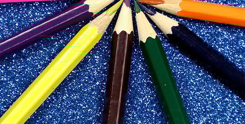 Colorful Pencils Arranged on Glittery Background